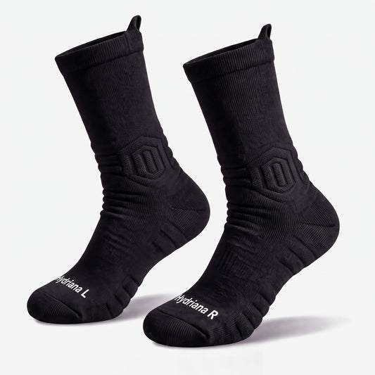 A pair of black athletic crew socks with white branding text on the toes, displayed against a clean white background.
